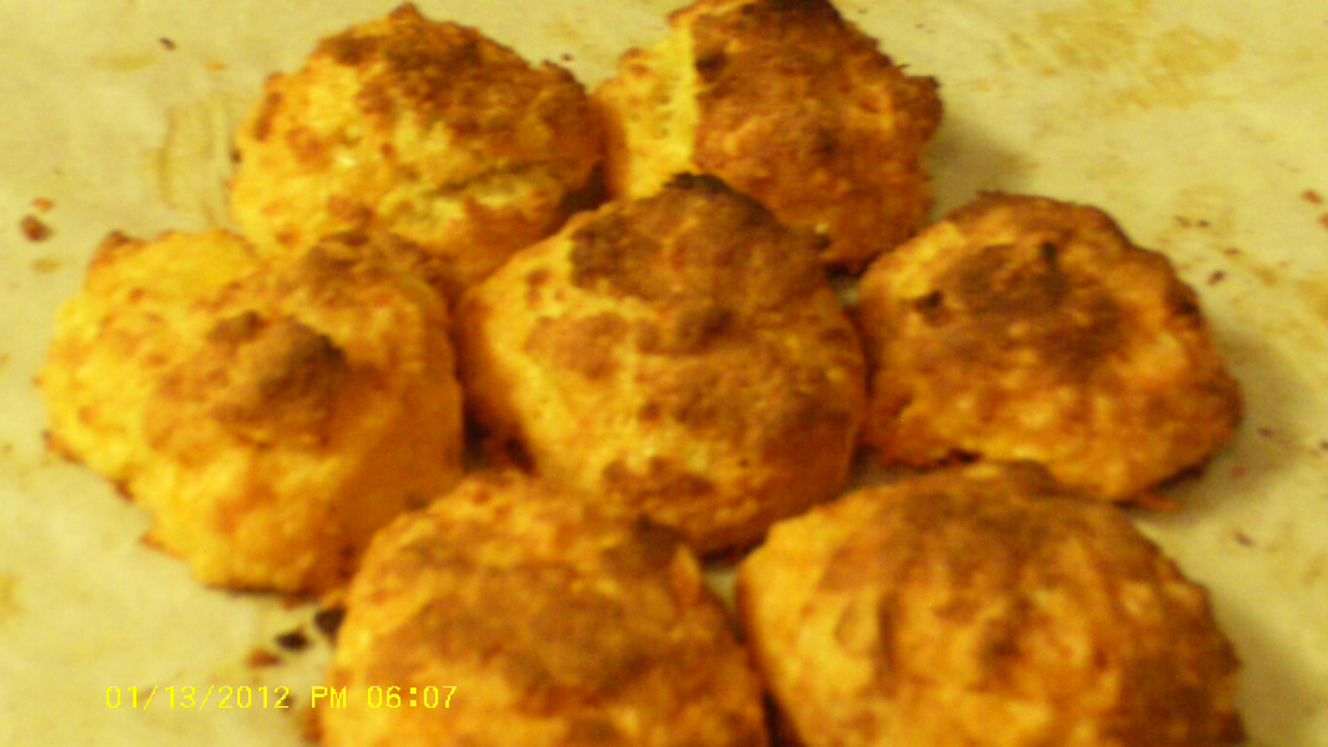 image of gluten-free garlic cheddar biscuits on parchment paper
